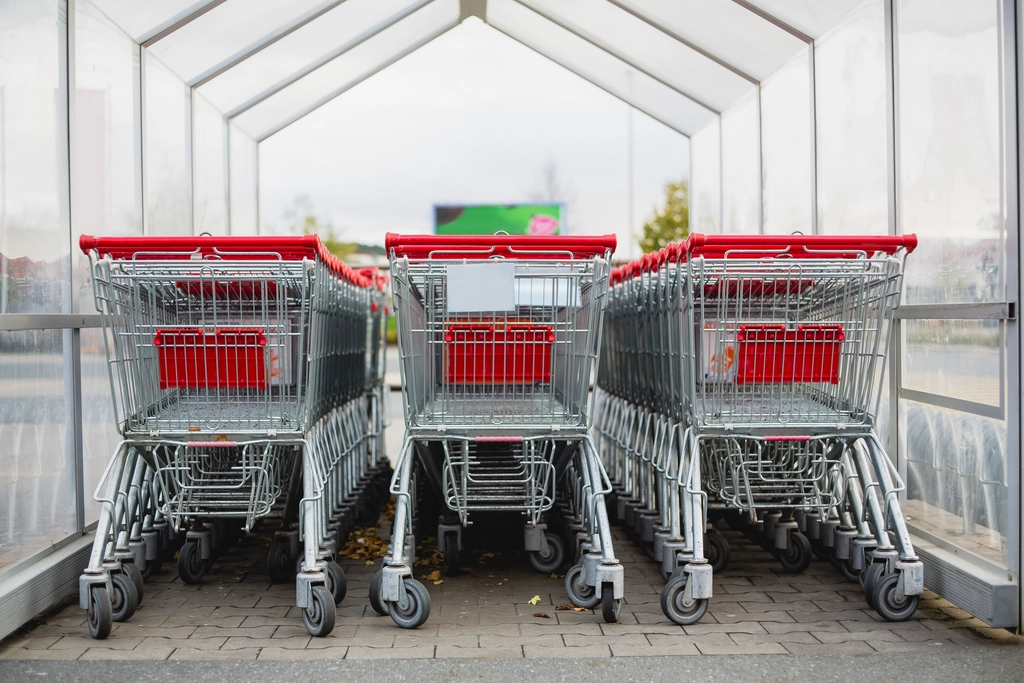 Shopping carts lined up outside a supermarket entrance
